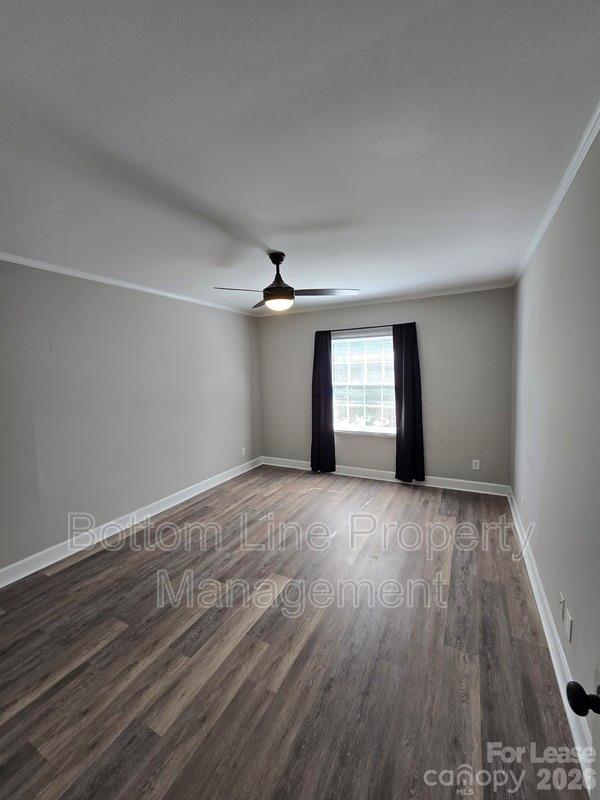 5949 Quail Hollow Road, Unit D Charlotte, NC 28210 - Photo 22 of 34 a view of an empty room with a window and wooden floor