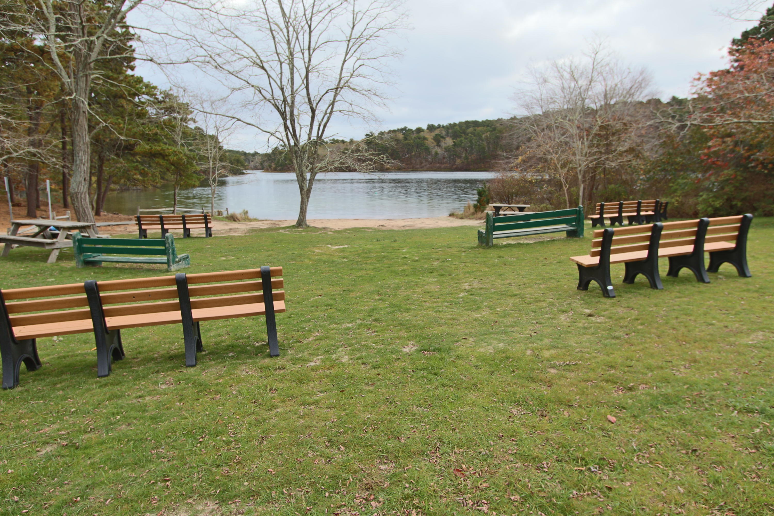 285 Long Pond Road Wellfleet, MA 02667 - Photo 24 of 28 a view of a bench in the garden near a lake
