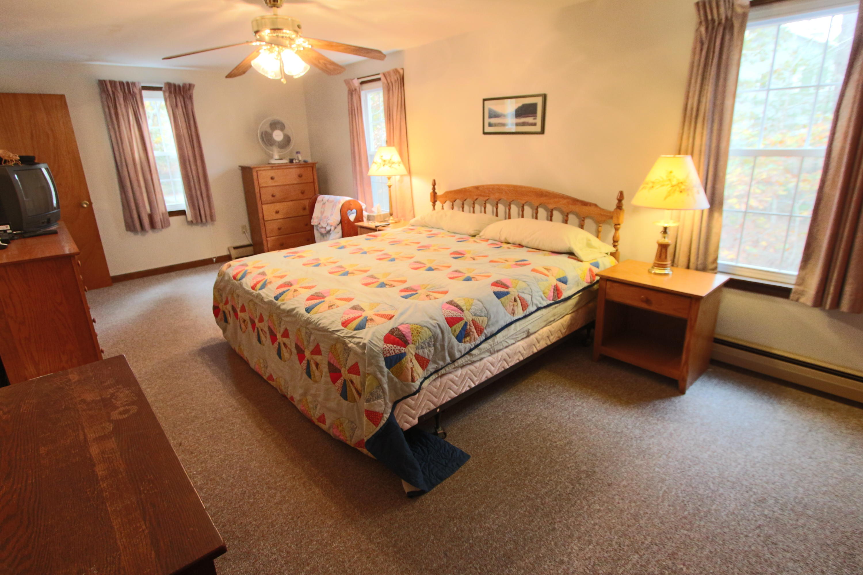 285 Long Pond Road Wellfleet, MA 02667 - Photo 4 of 28 a large bed sitting in a bedroom next to a window
