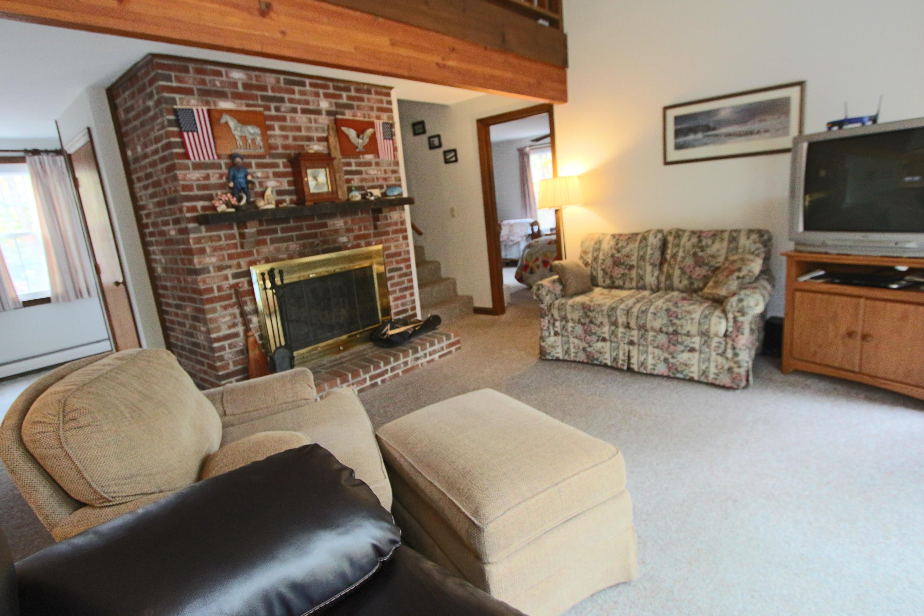 285 Long Pond Road Wellfleet, MA 02667 - Photo 5 of 28 a living room with furniture and a fireplace