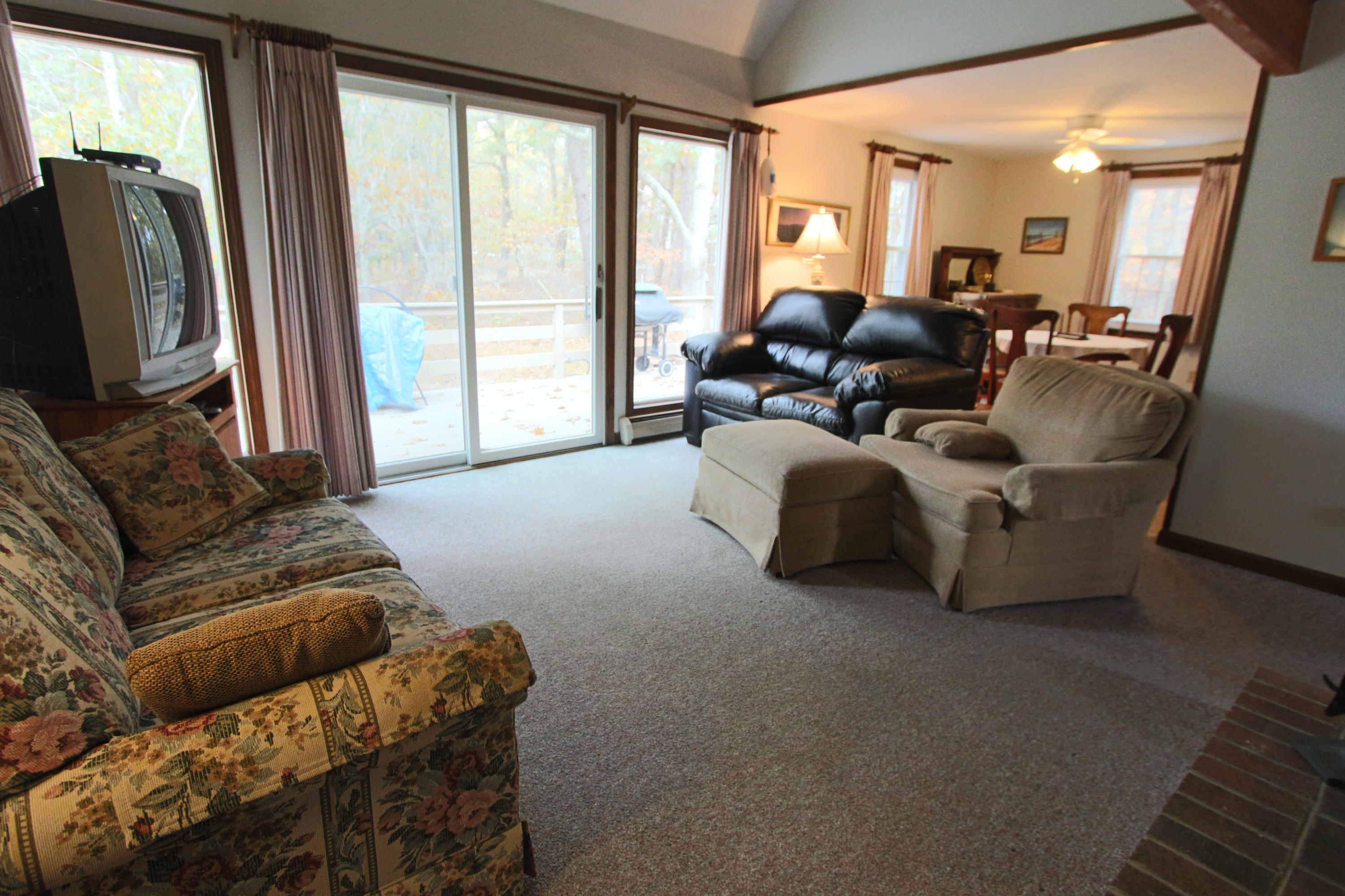 285 Long Pond Road Wellfleet, MA 02667 - Photo 8 of 28 a living room with furniture and a flat screen tv