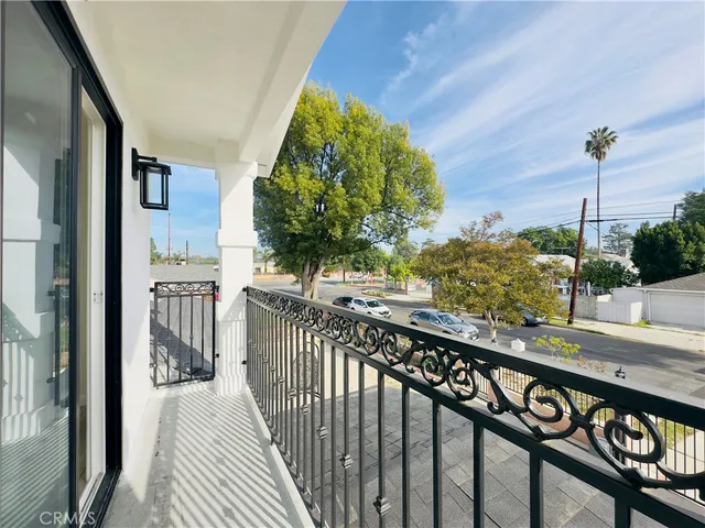 a view of a balcony with wooden floor and potted plants