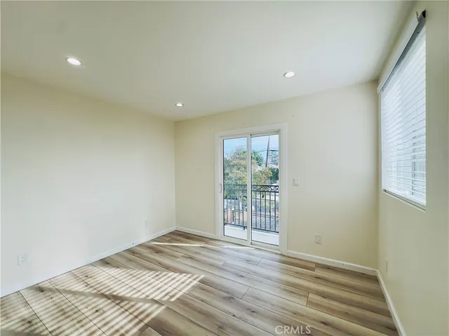 a view of a livingroom with wooden floor and entryway