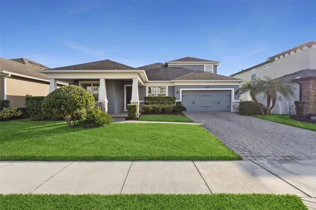 a front view of a house with a garden and yard