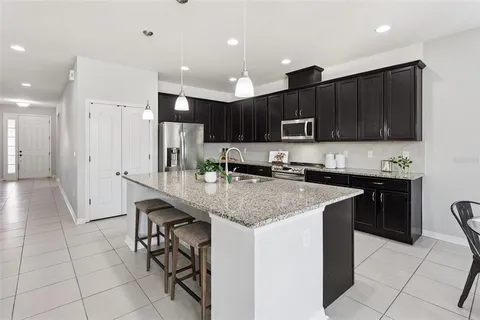 a kitchen with kitchen island granite countertop a sink and counter space