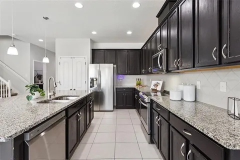 a living room with a couch and a potted plant