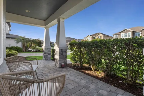 a view of a porch with furniture and garden
