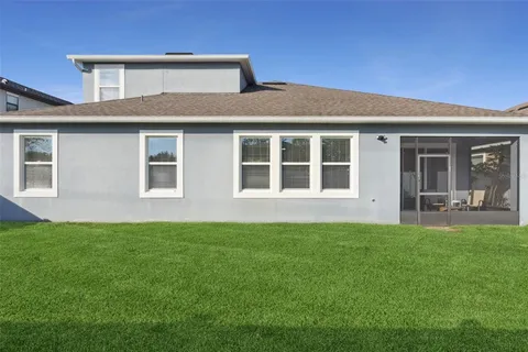 an aerial view of residential houses with outdoor space and swimming pool