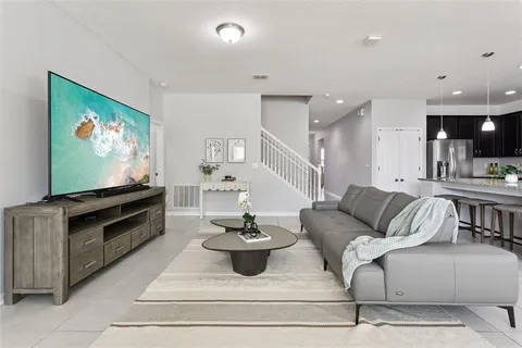 a living room with furniture and a flat screen tv
