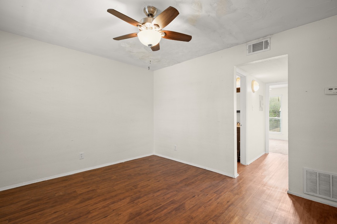 2401 Manor Road, Unit 206 Austin, TX 78722 - Photo 1 of 17 an empty room with wooden floor and a ceiling fan