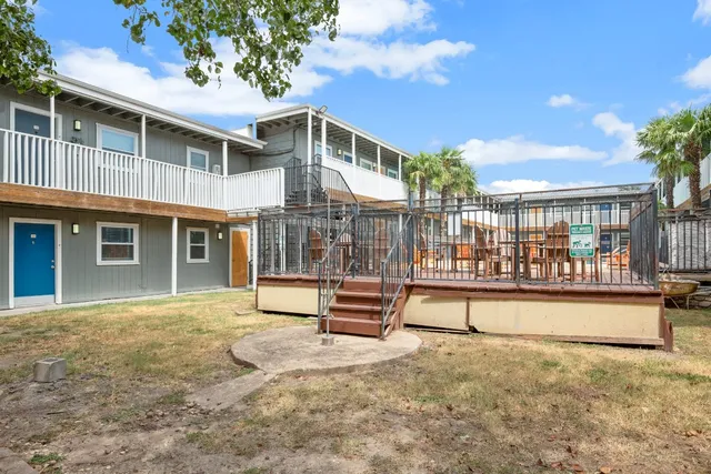 a view of a house with a wooden fence