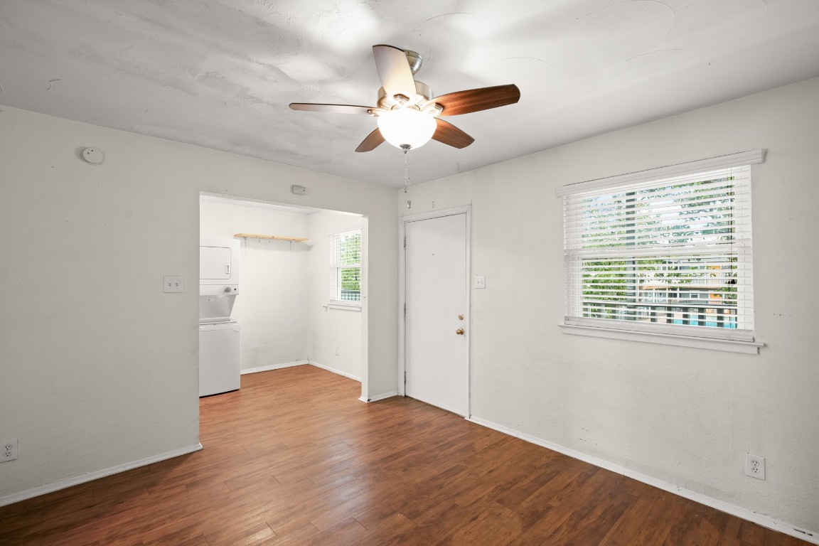 2401 Manor Road, Unit 206 Austin, TX 78722 - Photo 3 of 17 a view of an empty room with wooden floor and a window