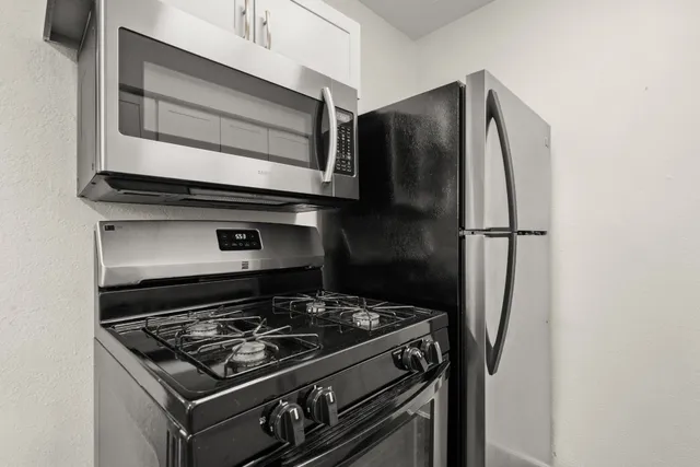 a stove top oven sitting inside of a kitchen