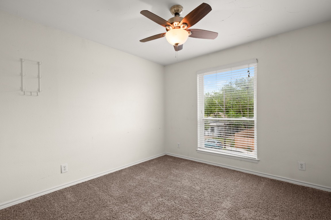 2401 Manor Road, Unit 206 Austin, TX 78722 - Photo 8 of 17 an empty room with a window and a fan