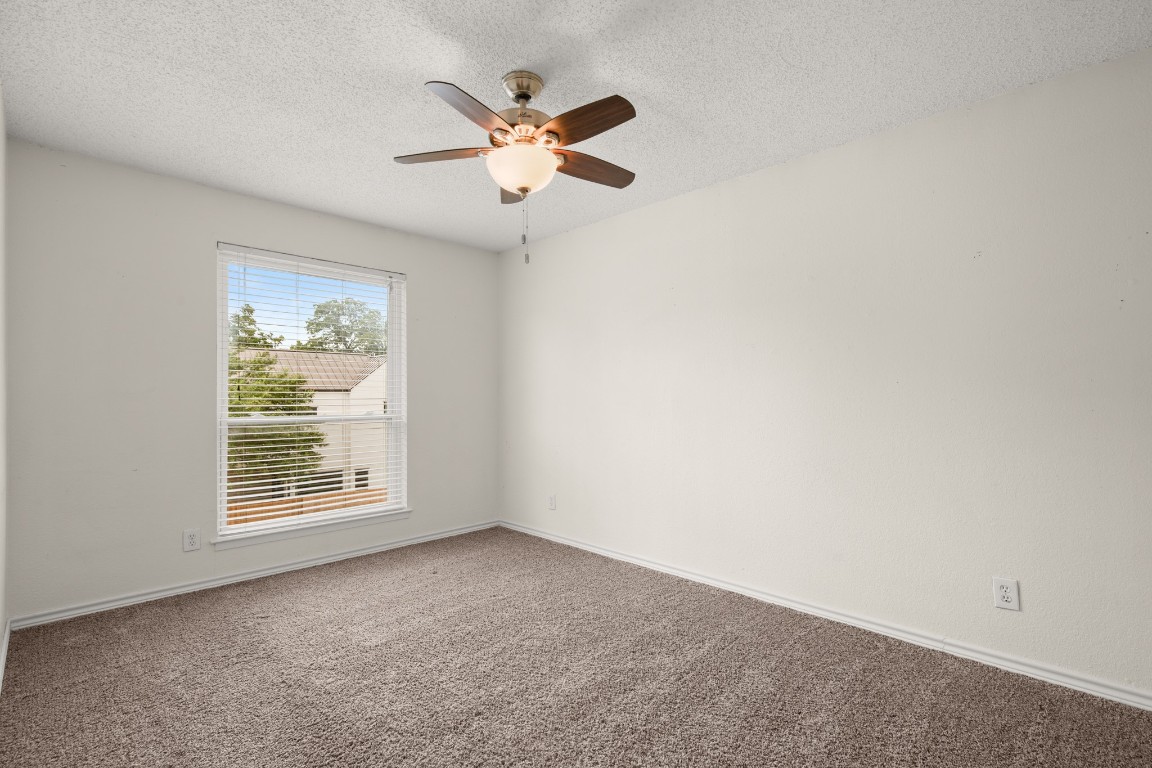 2401 Manor Road, Unit 206 Austin, TX 78722 - Photo 9 of 17 an empty room with windows and fan