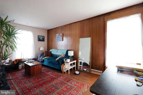 a bedroom with furniture and a wooden floor