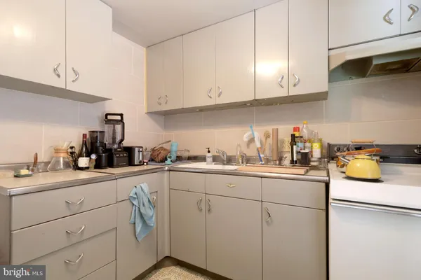 a kitchen with sink cabinets and appliances