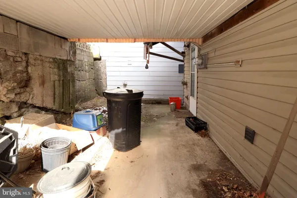 a view of a patio with table and chairs and barbeque grill with floor to ceiling window
