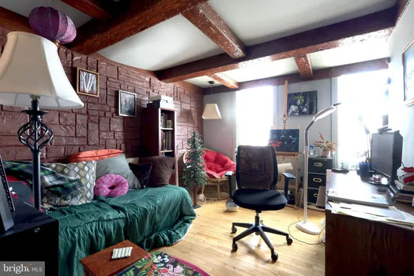 a bedroom with furniture and a lamp