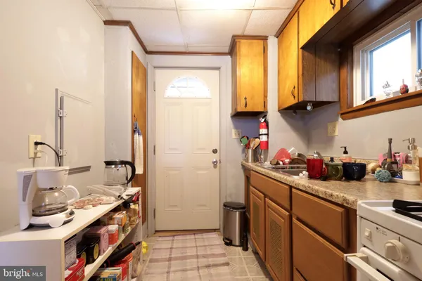 a kitchen with a sink stove and cabinets