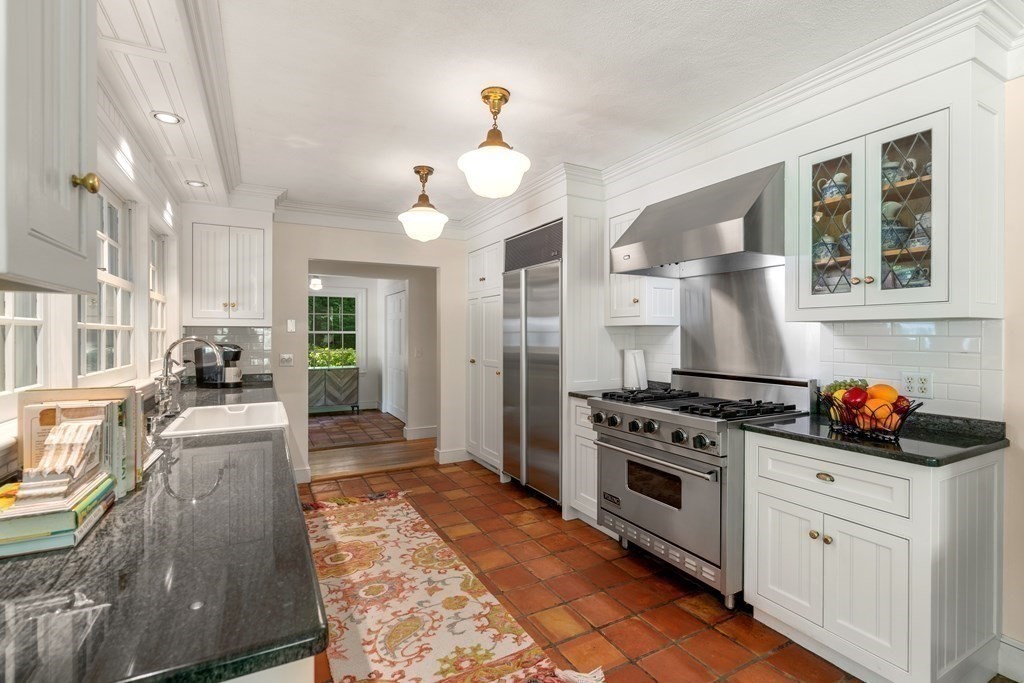 593 Peakham Road Sudbury, MA 01776 - Photo 16 of 42 a kitchen with stainless steel appliances granite countertop a stove a sink and a refrigerator