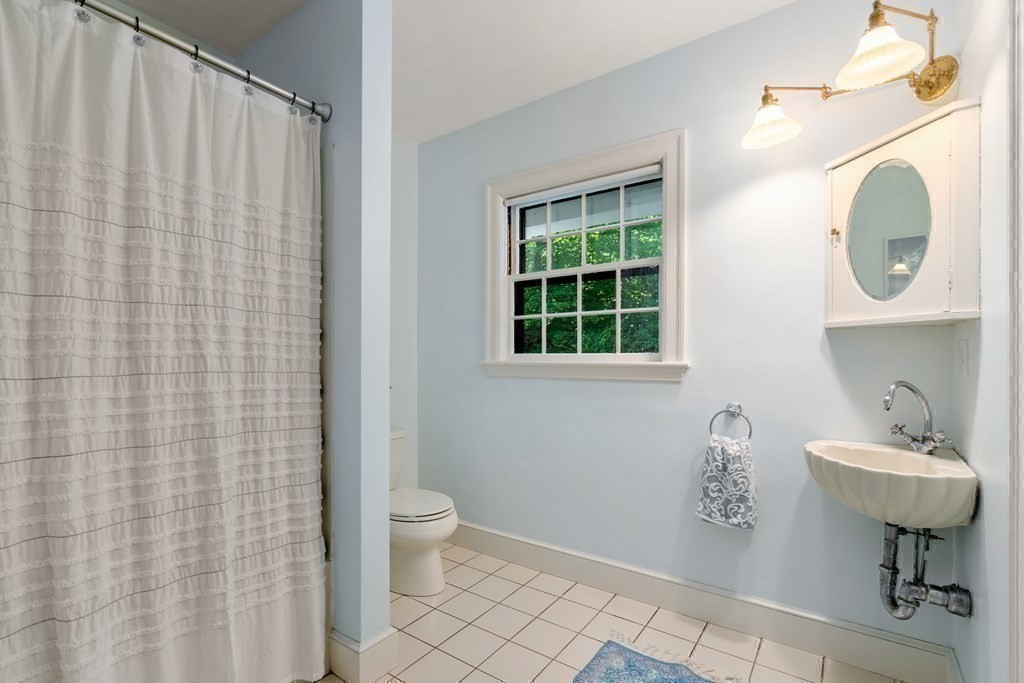 593 Peakham Road Sudbury, MA 01776 - Photo 25 of 42 a bathroom with a sink a toilet and a mirror