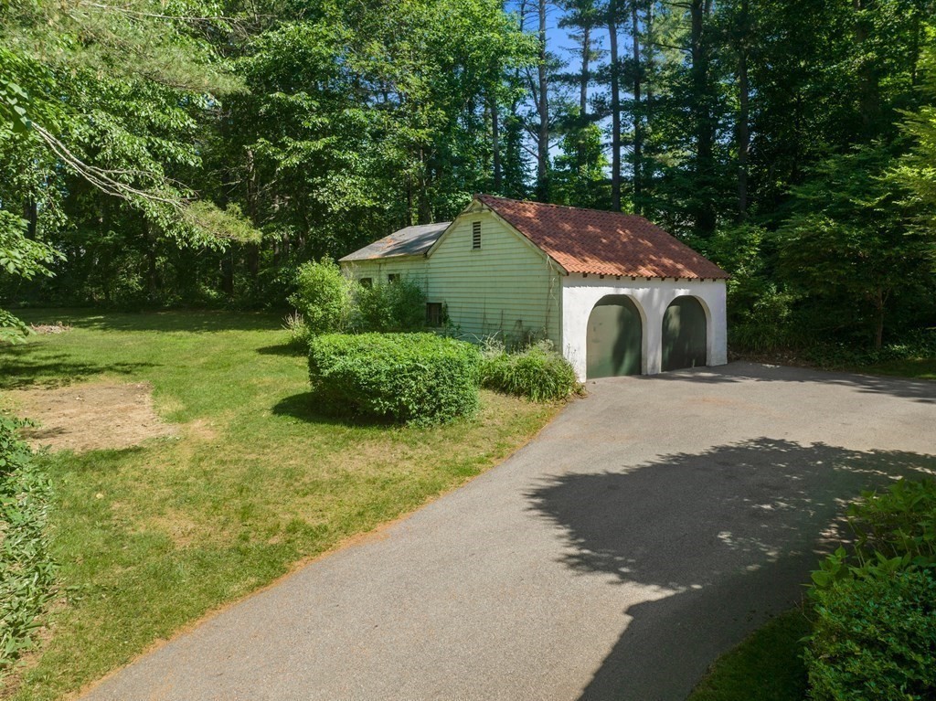593 Peakham Road Sudbury, MA 01776 - Photo 40 of 42 a front view of a house with a yard