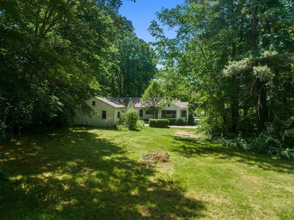 593 Peakham Road Sudbury, MA 01776 - Photo 42 of 42 a yellow house in middle of the green field