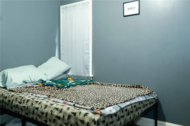 a bed sitting in a bedroom next to a wall