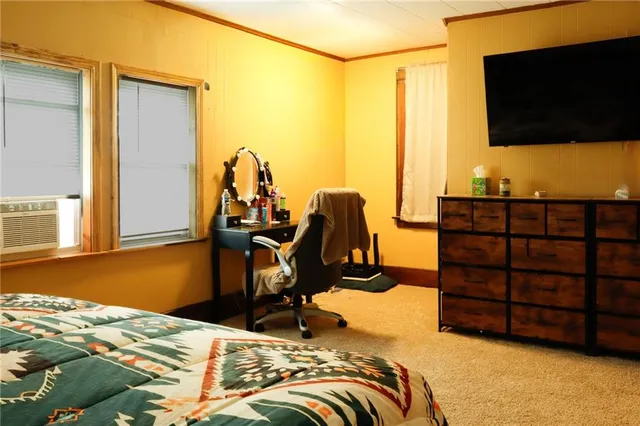 a bed room with a bed and a flat screen tv