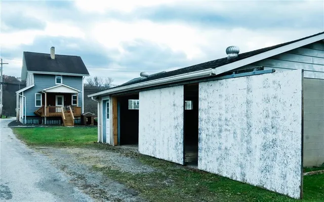 a backyard of a house with table and chairs