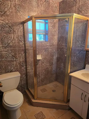 a bathroom with a shower and toilet