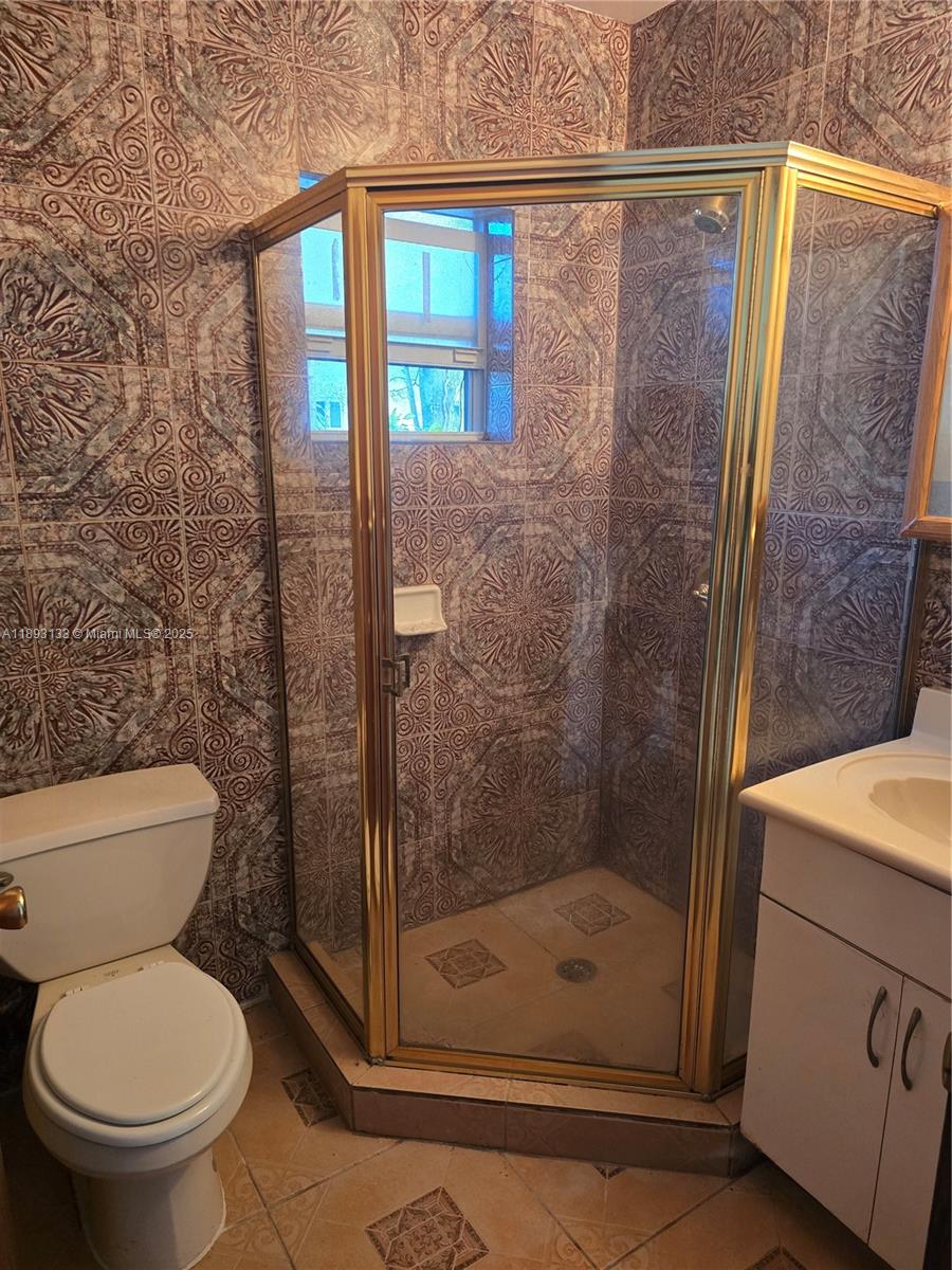 4716 Southwest 1st Street, Unit A Miami, FL 33134 - Photo 1 of 5 a bathroom with a shower and toilet