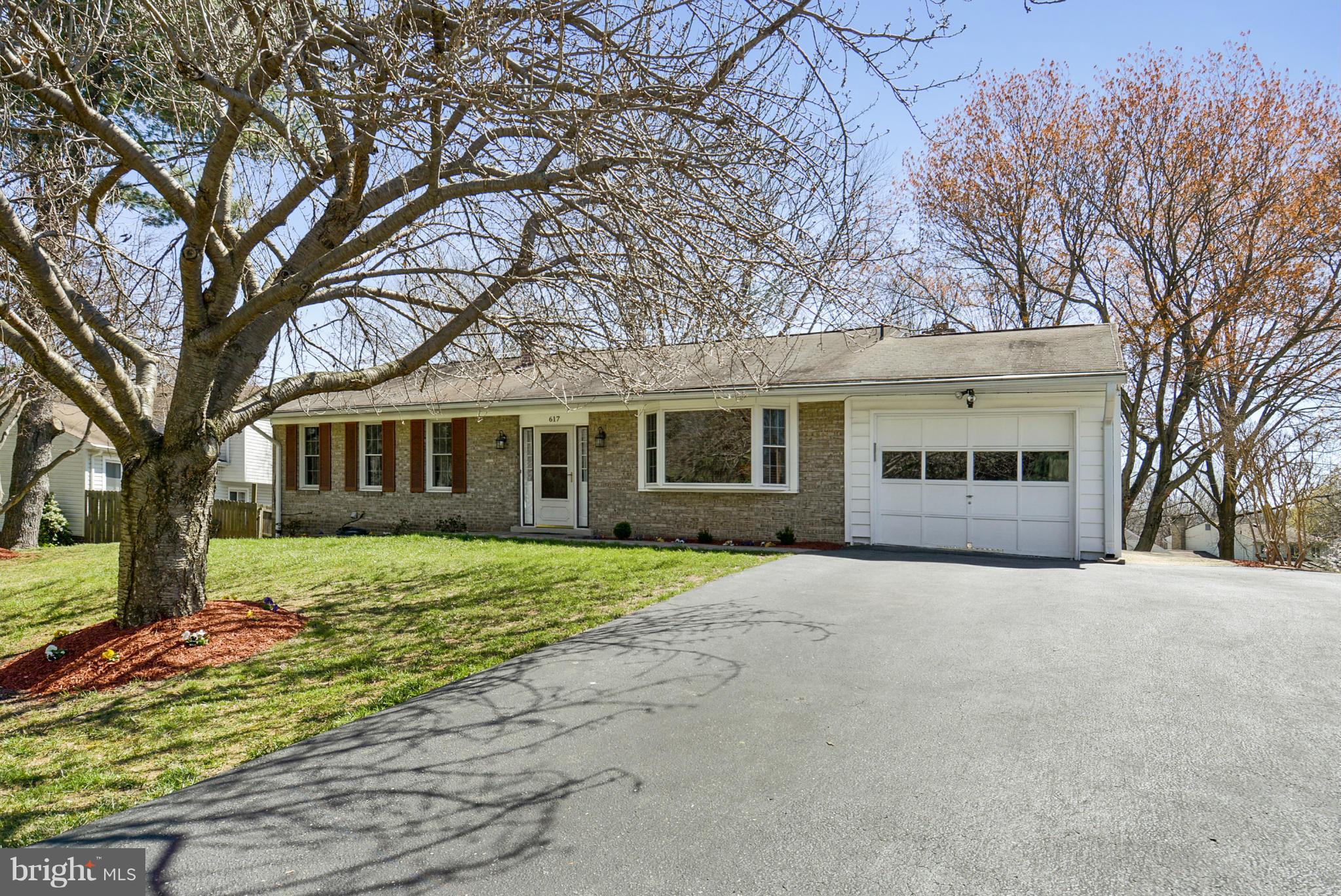 617 Windmill Lane Silver Spring, MD 20905 - Photo 1 of 20 a front view of a house with a garden and trees