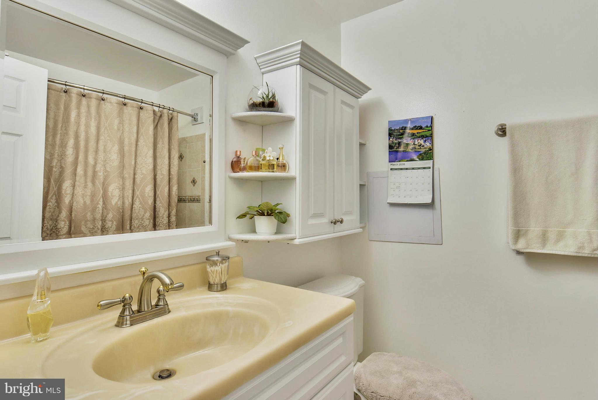 617 Windmill Lane Silver Spring, MD 20905 - Photo 13 of 20 a bathroom with a sink and a mirror