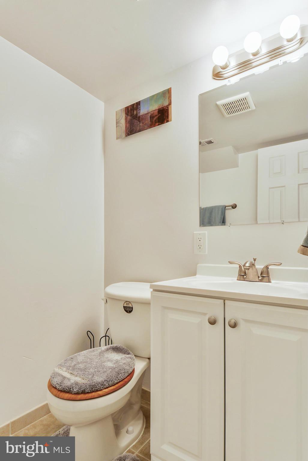 617 Windmill Lane Silver Spring, MD 20905 - Photo 14 of 20 a bathroom with a sink a toilet and a mirror