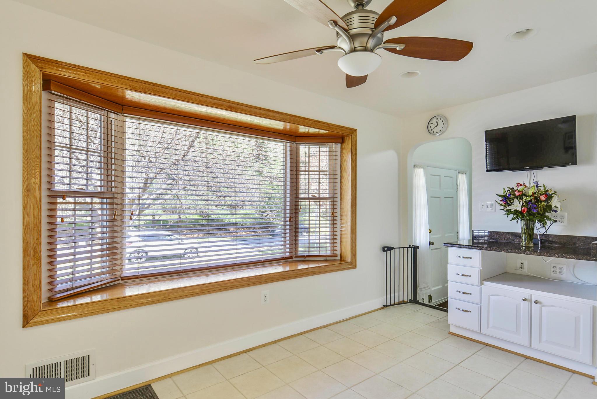 617 Windmill Lane Silver Spring, MD 20905 - Photo 4 of 20 a spacious bedroom with a large bed and a flat tv screen