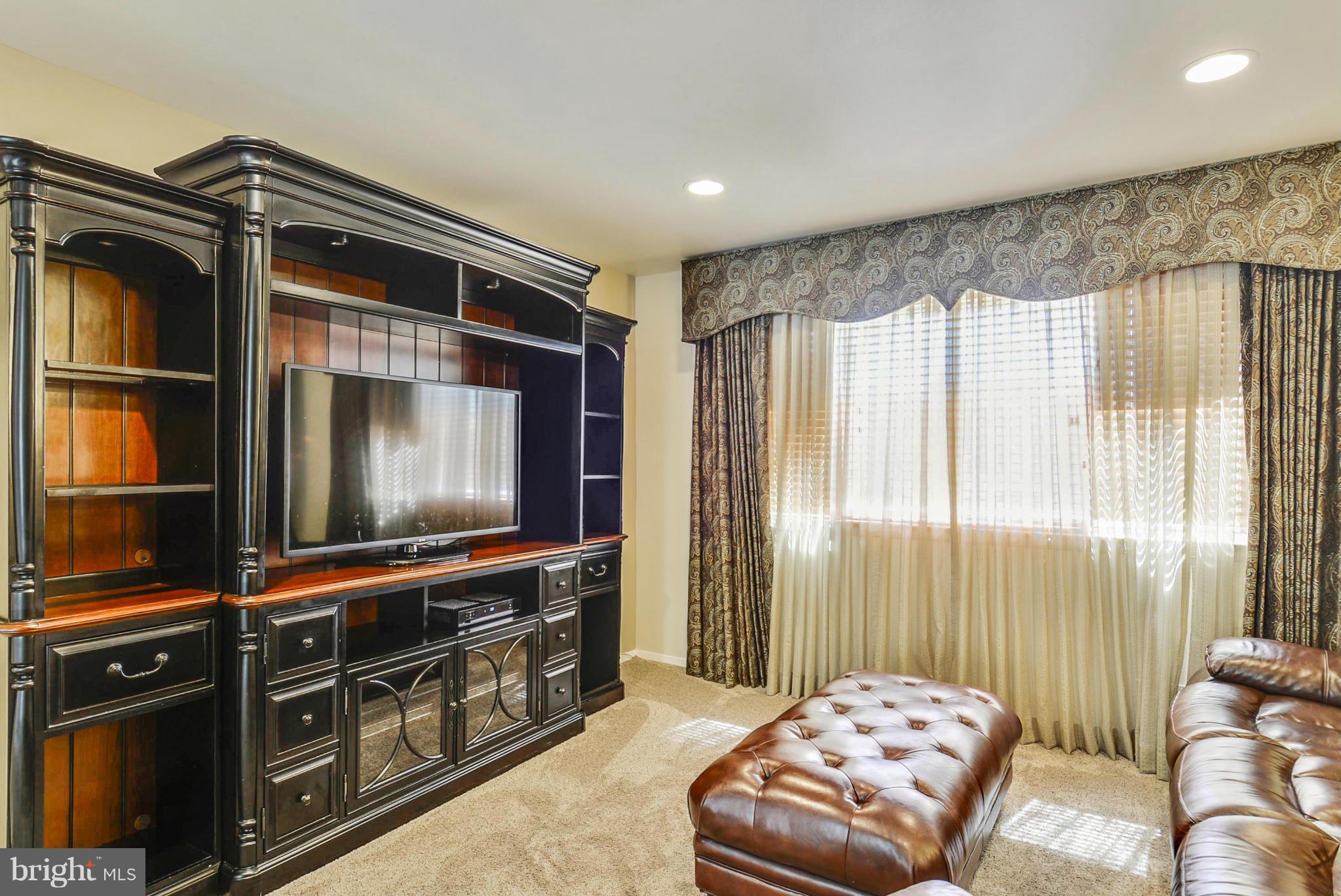 617 Windmill Lane Silver Spring, MD 20905 - Photo 7 of 20 a living room with furniture and a flat screen tv