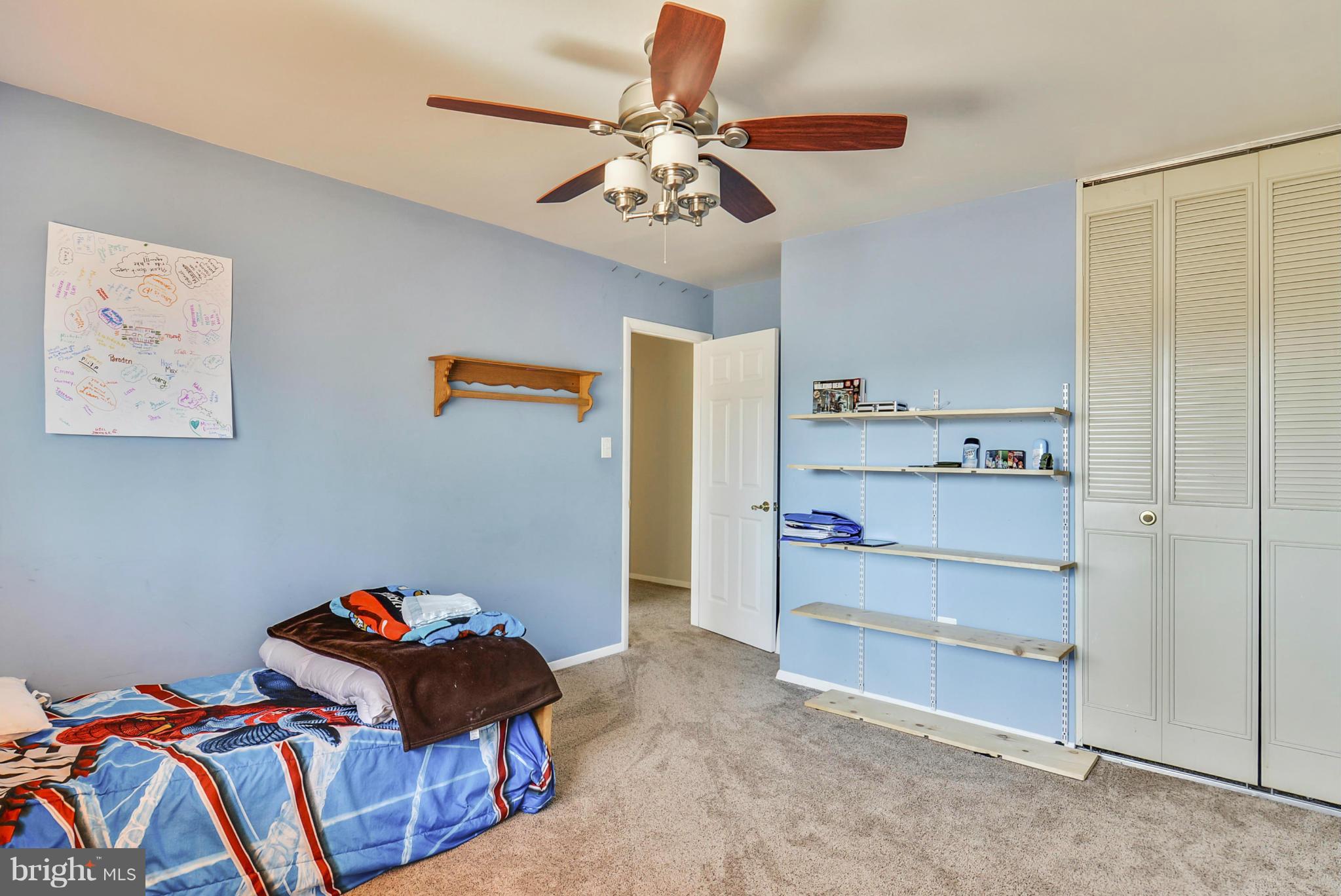 617 Windmill Lane Silver Spring, MD 20905 - Photo 10 of 20 a bedroom with a bed and a chandelier