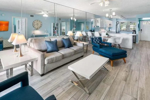 a living room with furniture and a chandelier