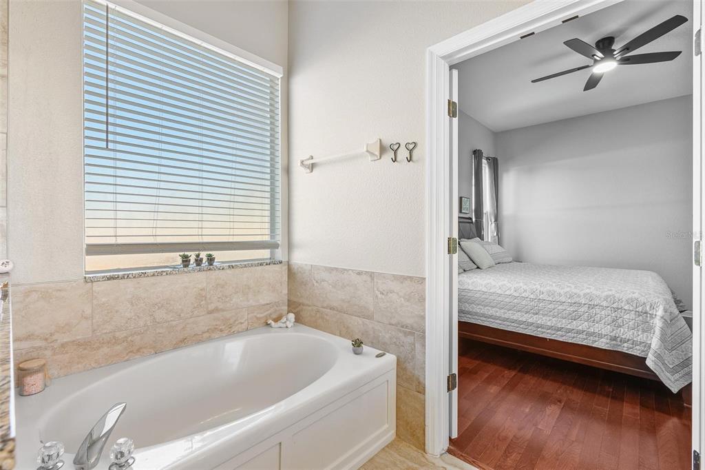 717 Strihal Loop Oakland, FL 34787 - Photo 15 of 32 a bathroom with a tub and a sink