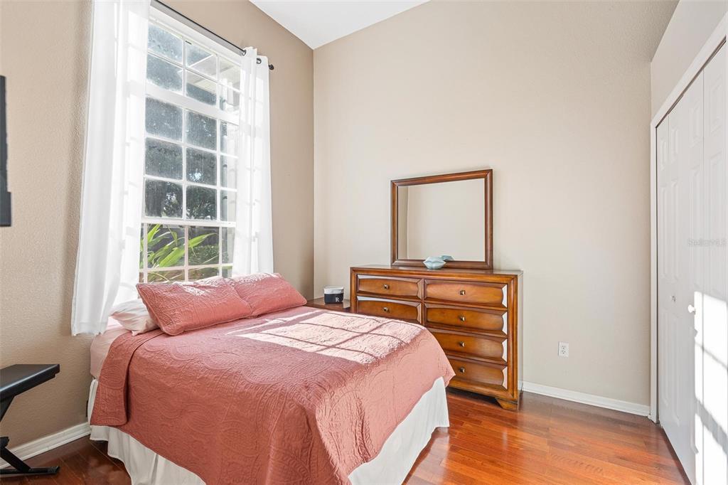 717 Strihal Loop Oakland, FL 34787 - Photo 18 of 32 a bedroom with a bed and a window