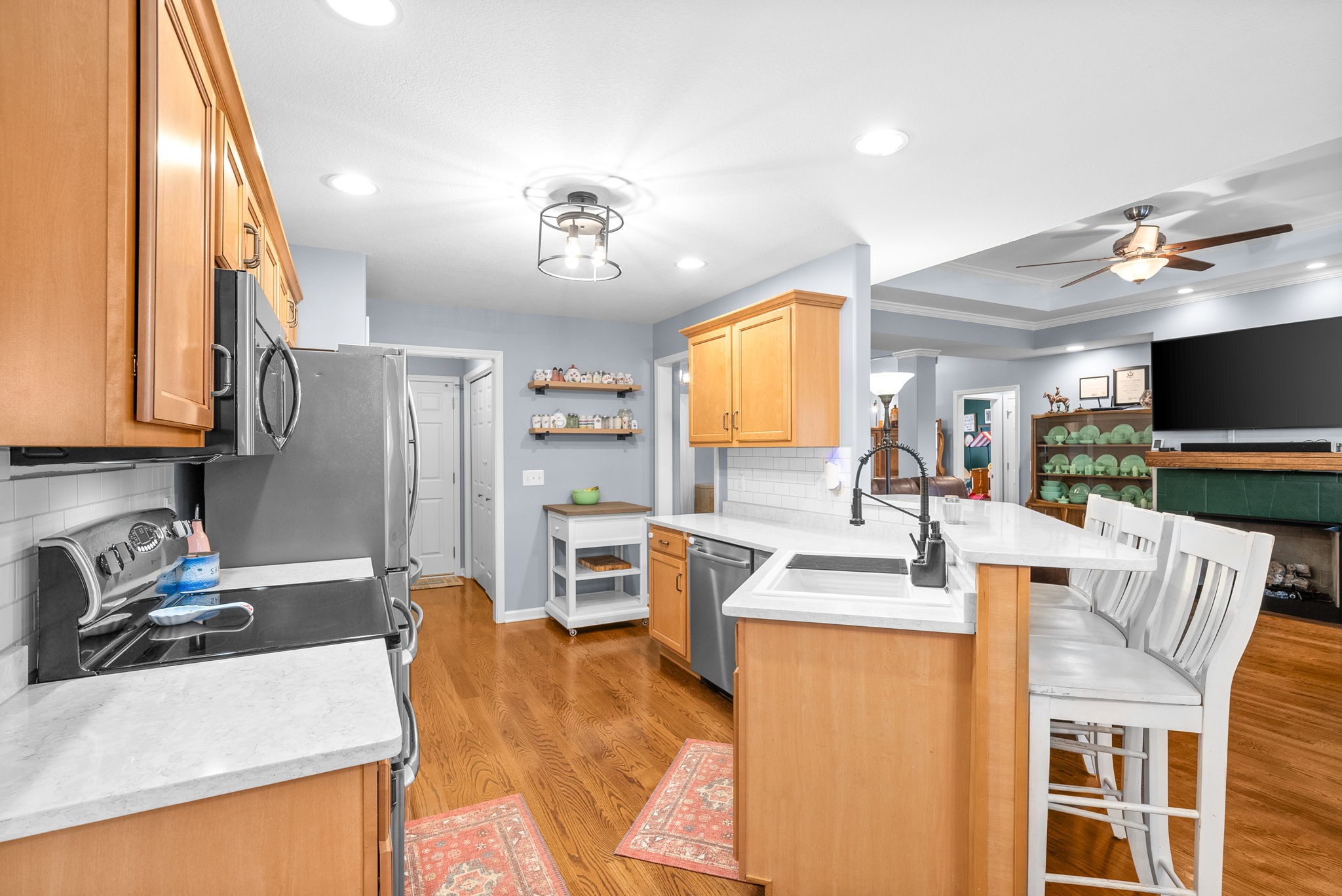 1221 Olive Branch Road Clarksville, TN 37042 - Photo 14 of 36 a room with stainless steel appliances kitchen island granite countertop a table chairs and a refrigerator