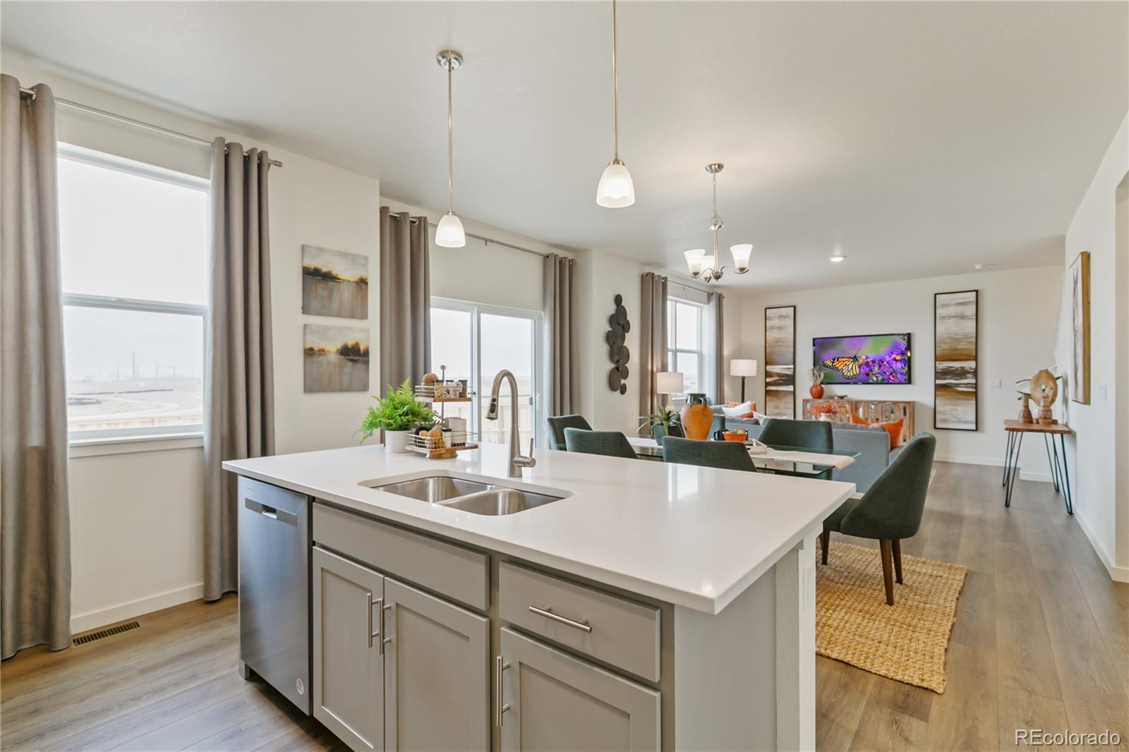 9935 Ceylon Court Commerce City, CO 80022 - Photo 12 of 44 a kitchen with center island and stainless steel appliances