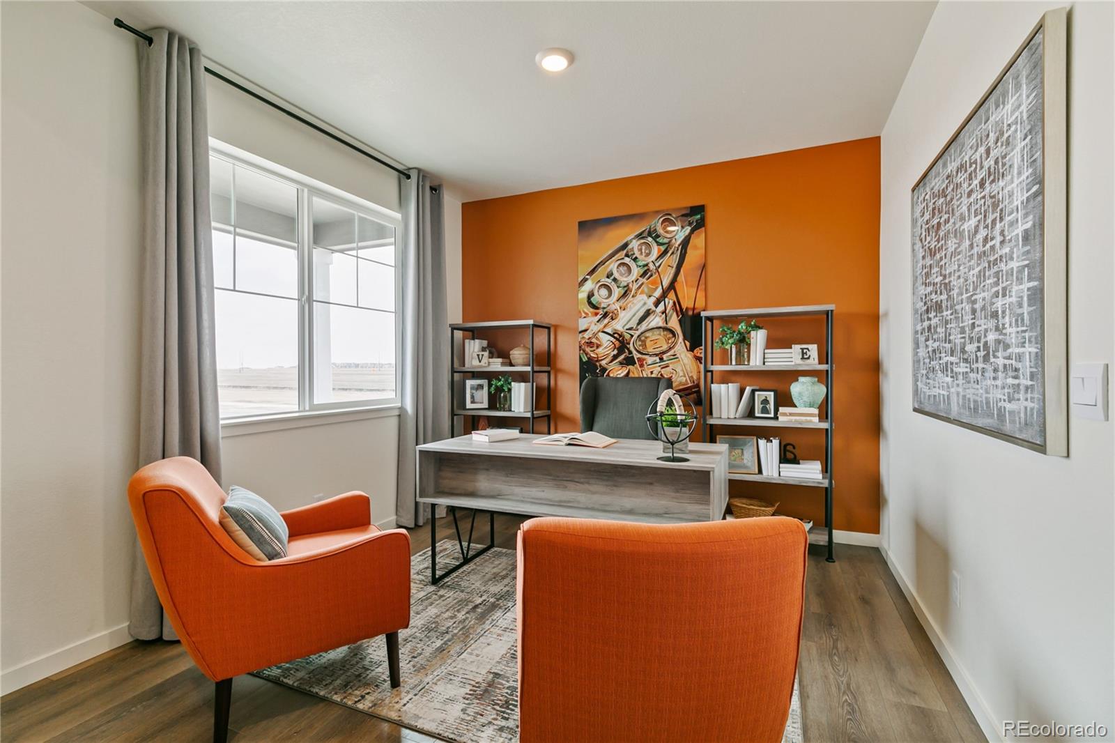 9935 Ceylon Court Commerce City, CO 80022 - Photo 14 of 44 a living room with furniture a rug and a window