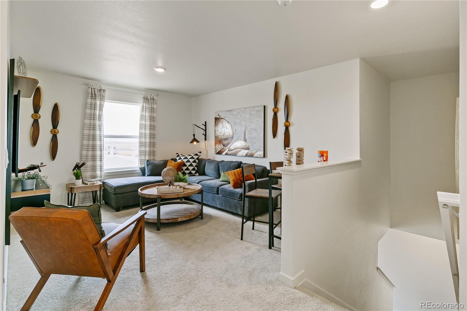 9935 Ceylon Court Commerce City, CO 80022 - Photo 17 of 44 a living room with furniture and a window