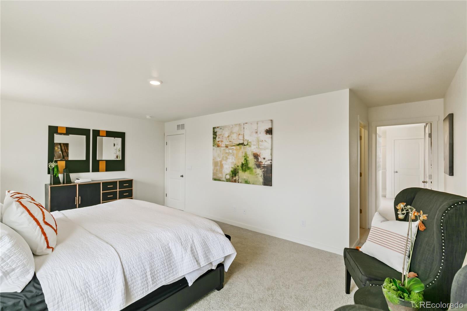 9935 Ceylon Court Commerce City, CO 80022 - Photo 22 of 44 a bedroom with a bed and a workspace