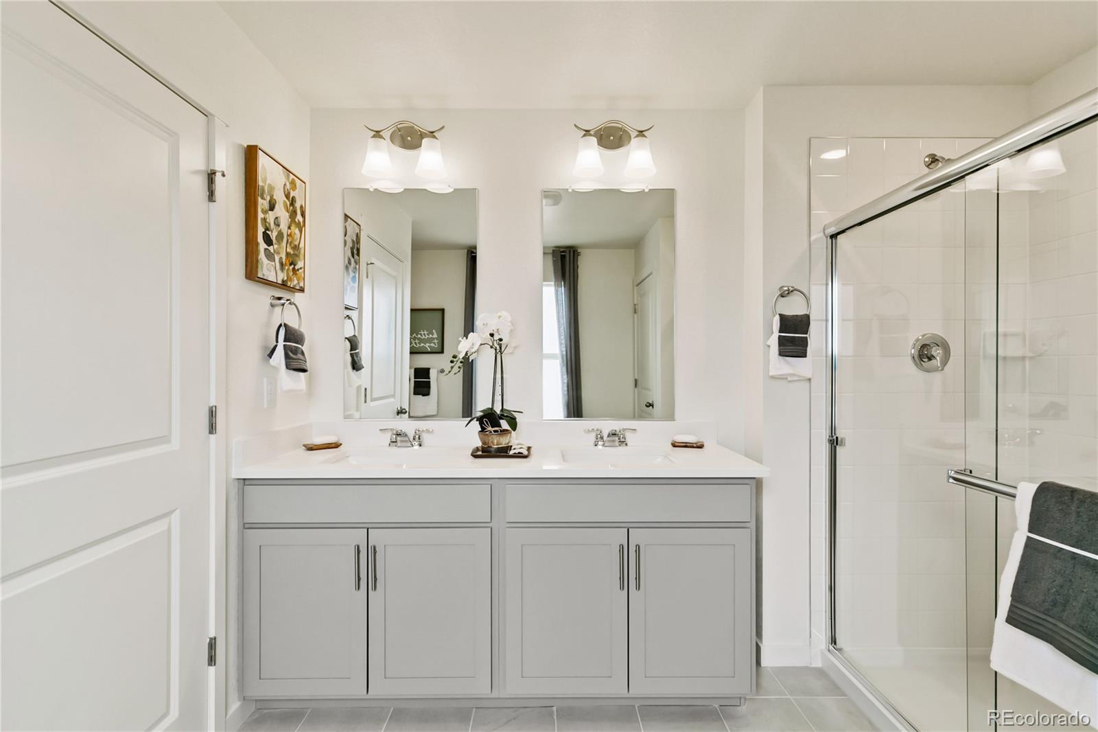 9935 Ceylon Court Commerce City, CO 80022 - Photo 24 of 44 a bathroom with a double vanity sink mirror and double