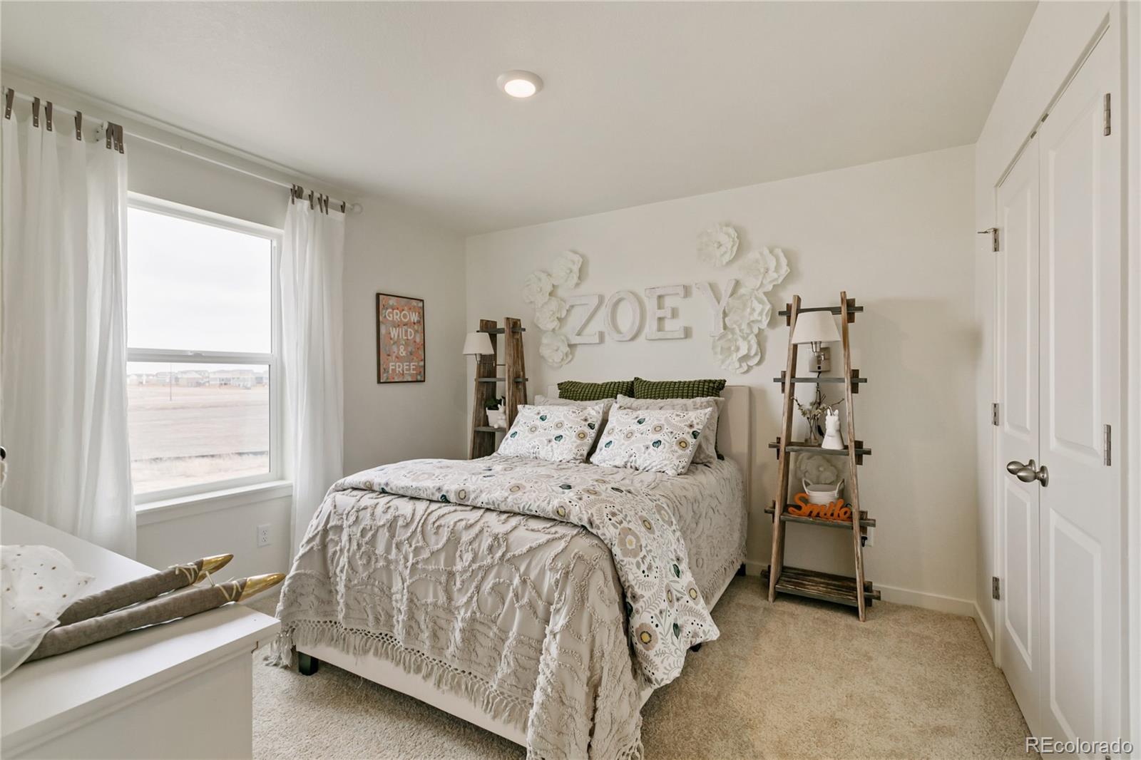 9935 Ceylon Court Commerce City, CO 80022 - Photo 28 of 44 a bedroom with a bed and a window