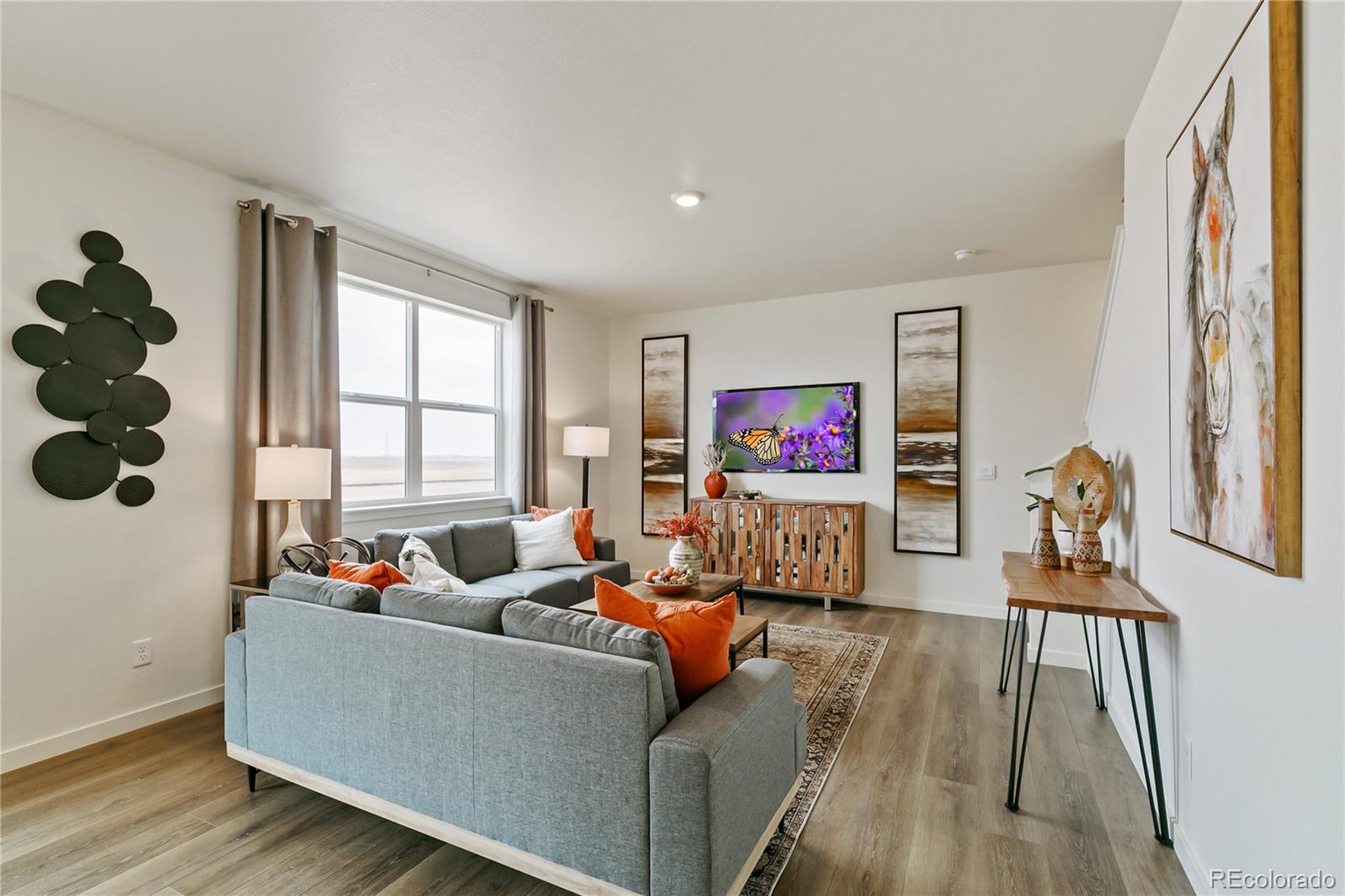 9935 Ceylon Court Commerce City, CO 80022 - Photo 5 of 44 a living room with furniture and a flat screen tv